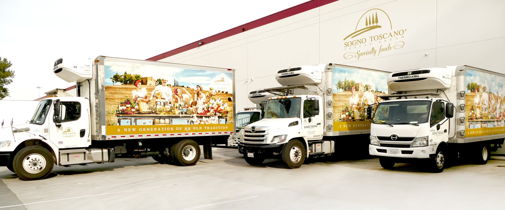 Three Sogno Toscano refrigerated trucks outside the Specialty Foods warehouse